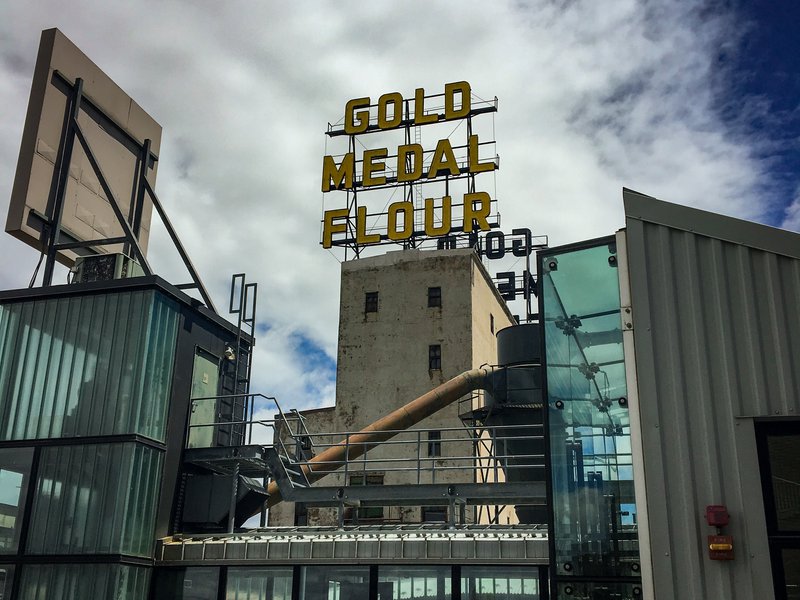 A large, neon sign above the Mill City Museum reads "GOLD MEDAL FLOUR".