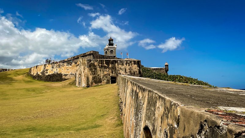 A fortified stone wall stretched out and connects to San Felipe del Morro Castle.